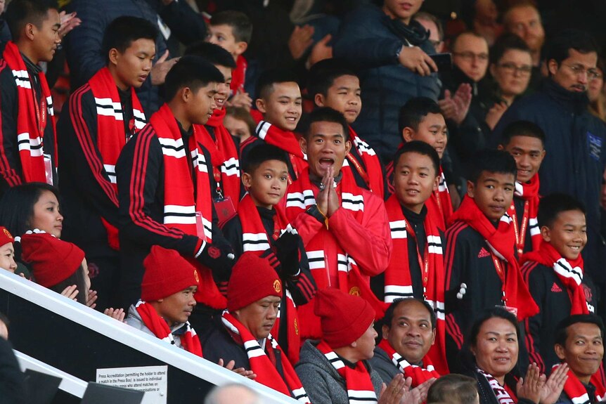 Thai Cave rescue boys smile while wearing Manchester United scarves