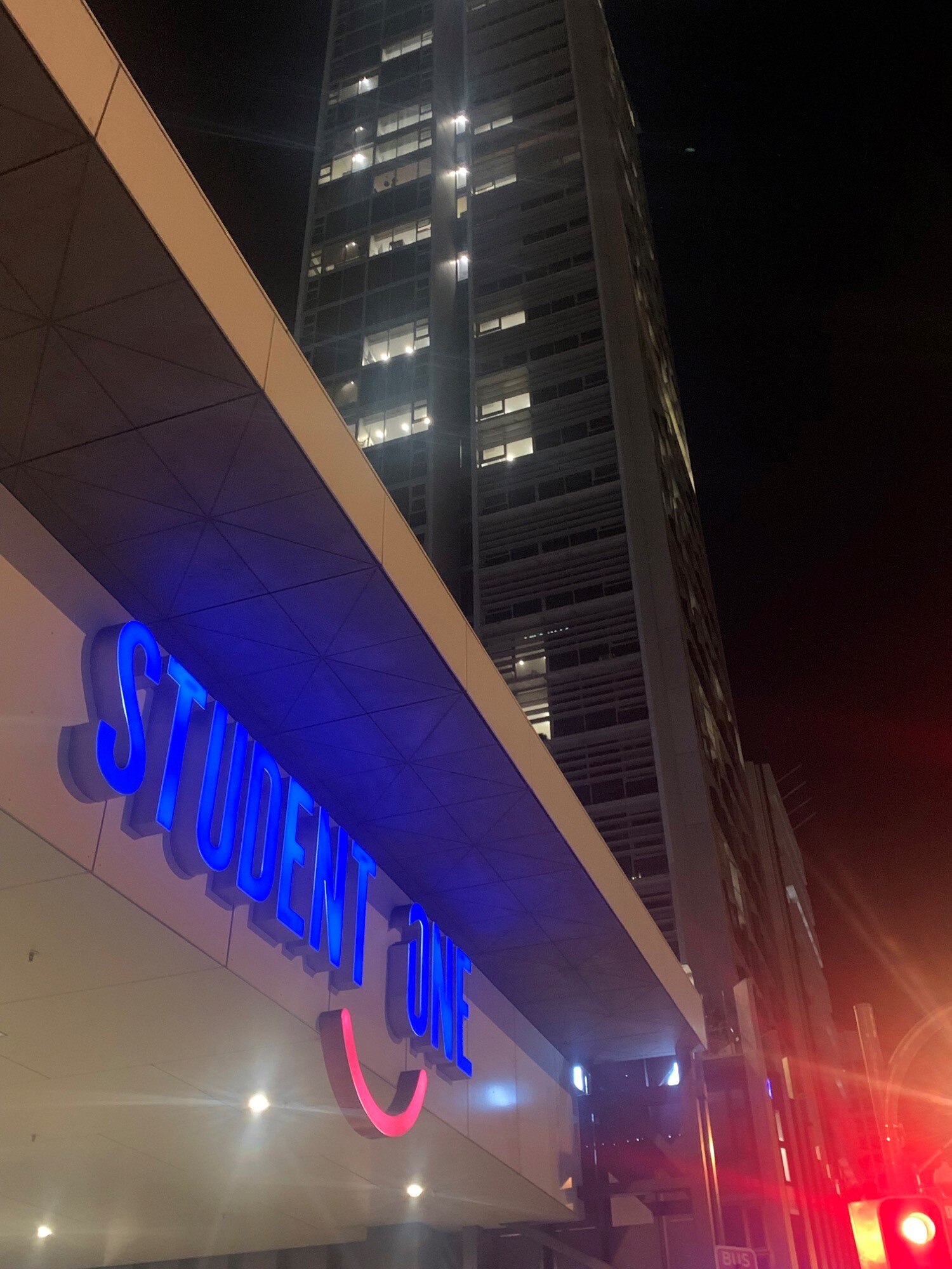 Student One's neon sign at night.