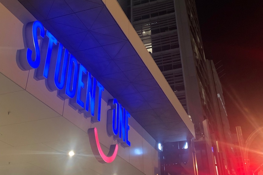 Student One's neon sign at night.