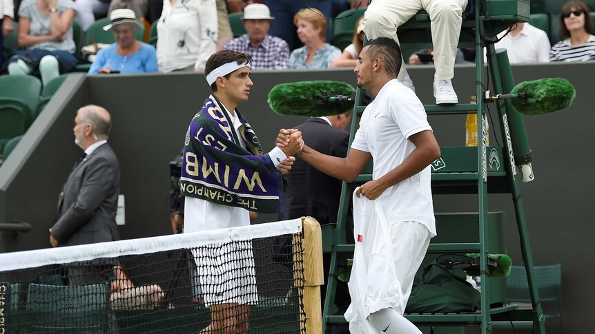 Nick Kyrgios shakes hands with France's Pierre-Hugues Herbert after sustaining an injury
