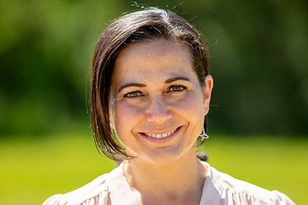 A woman smiling into the camera.