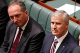 Michael McCormack sits between Barnaby Joyce and Warren Truss in the House of Representatives.