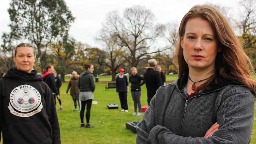 two women standing with serious faces