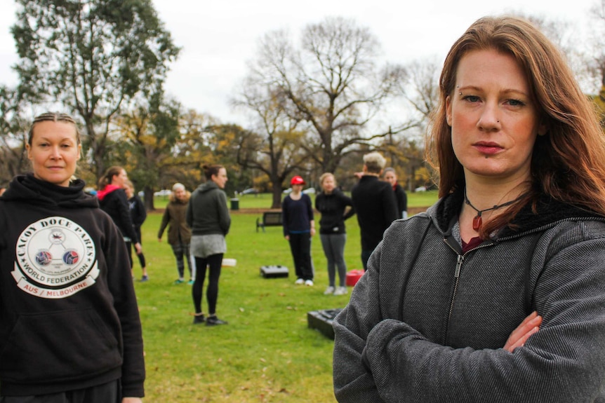 two women standing with serious faces