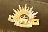 close up of a Rising Sun badge on the side of a slouch hat worn by a member of the Australian Army-1