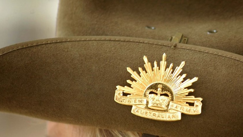 close up of a Rising Sun badge on the side of a slouch hat worn by a member of the Australian Army-1