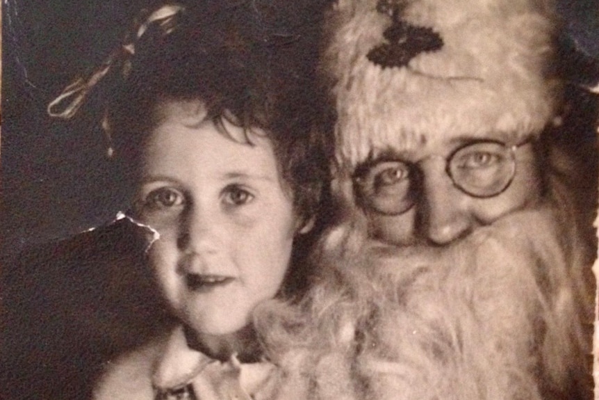 An old photograph of a young girl with santa