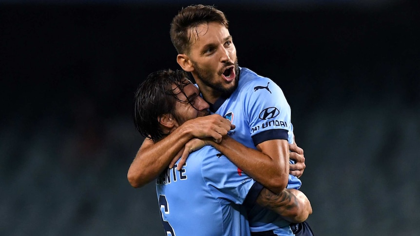 Milos Ninkovic (right) of Sydney is congratulated by Joshua Brilliante after scoring a goal during the round 19 A-League match between Sydney FC and the Wellington Phoenix at Allianz Stadium in Sydney