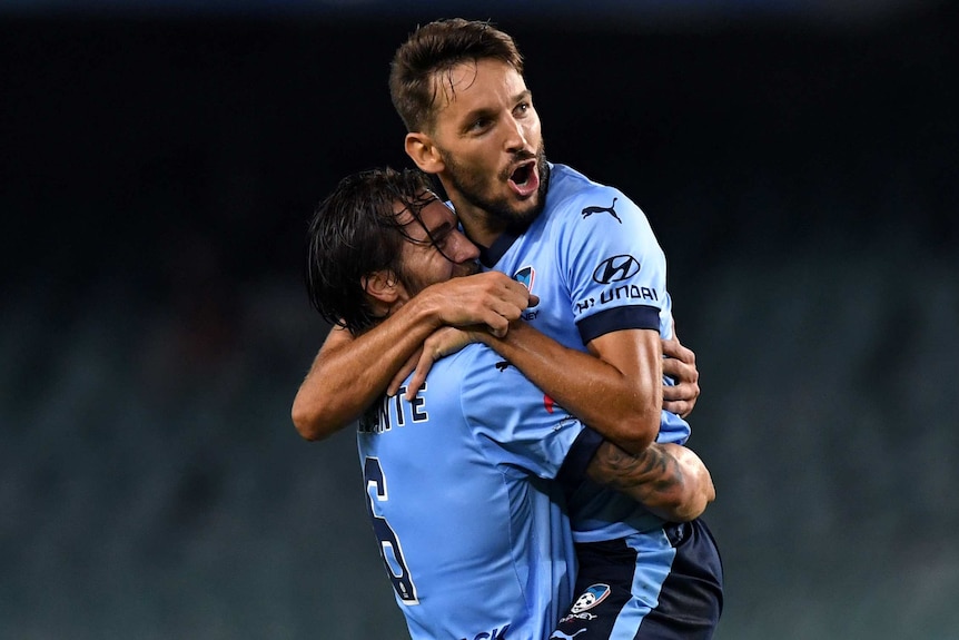 Milos Ninkovic (right) of Sydney is congratulated by Joshua Brilliante after scoring a goal during the round 19 A-League match between Sydney FC and the Wellington Phoenix at Allianz Stadium in Sydney