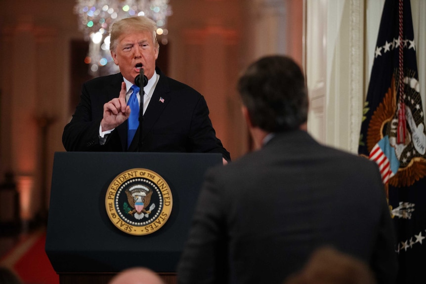 President Donald Trump speaks to CNN journalist Jim Acosta during a news conference, wagging his finger at the reporter.