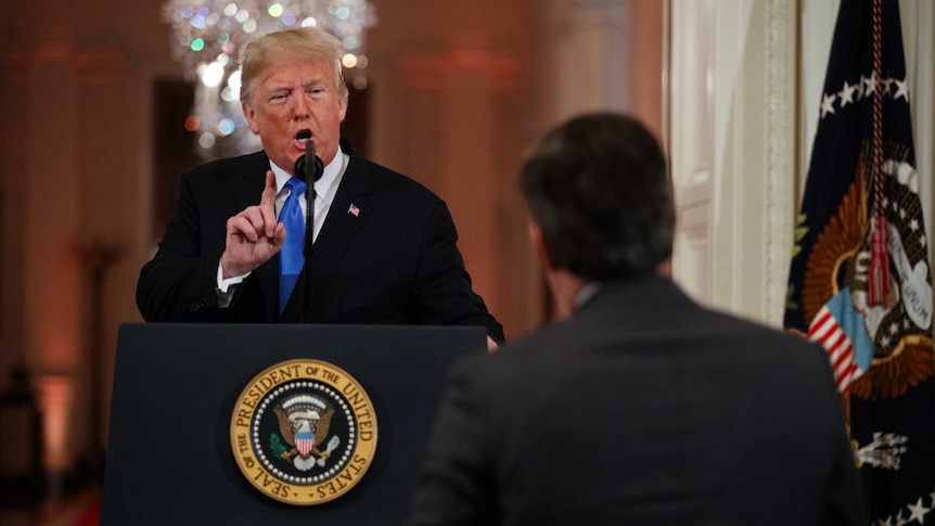 President Donald Trump speaks to CNN journalist Jim Acosta during a news conference, wagging his finger at the reporter.