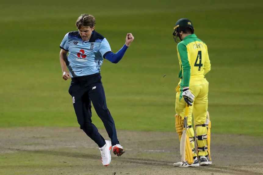 Sam Curran pumps his fist to celebrate a wicket as Alex Carey looks downcast.