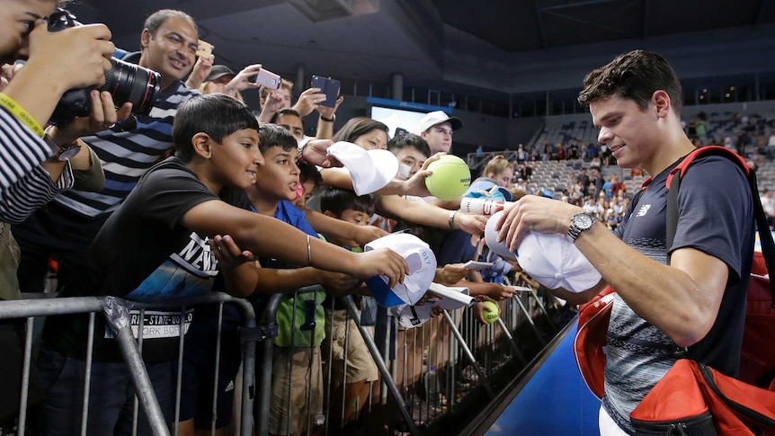 Canada's Milos Raonic signs autographs after his Australian Open win over Roberto Bautista Agut.