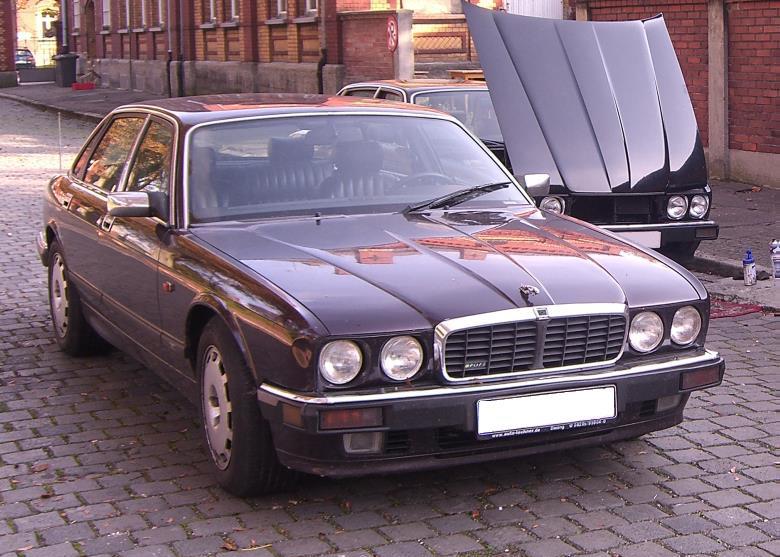 A maroon car parked in a street