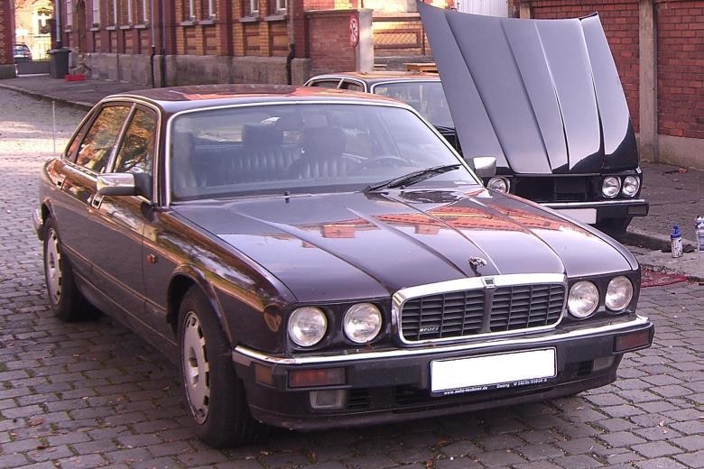 A maroon car parked in a street