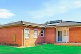 A house with an unnaturally green lawn