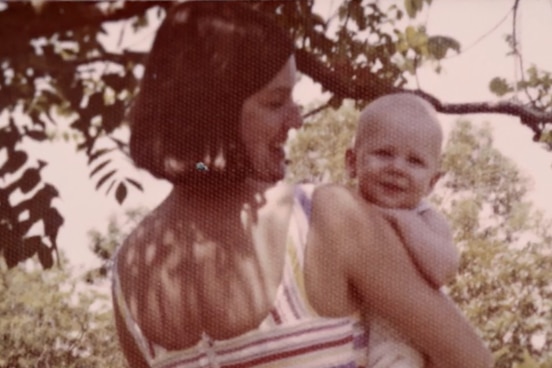 Sepia image of woman holding bald-headed baby