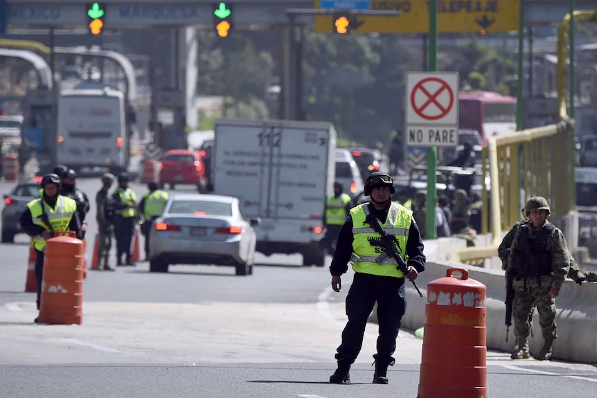 Federal Police officers and soldiers are seen at a checkpoint in Mexico City