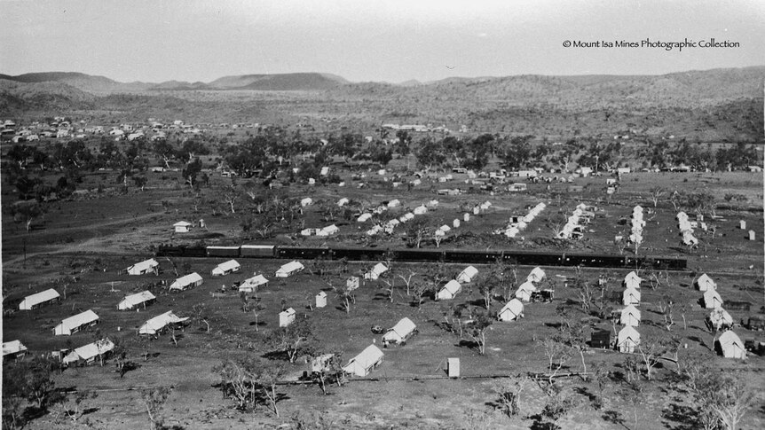 Black and white photo of Mount Isa Mail train passing through Tent City, in 1931.