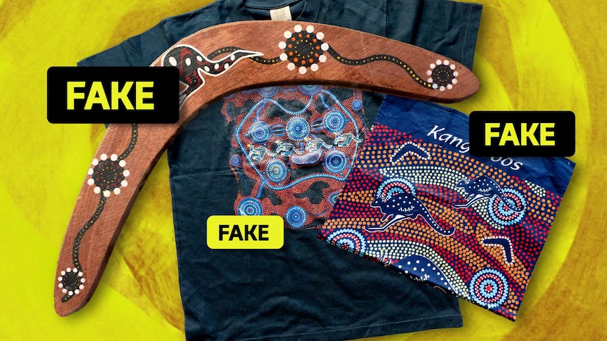 A t-shirt, boomerang and tea towel decorated with fake aboriginal art.