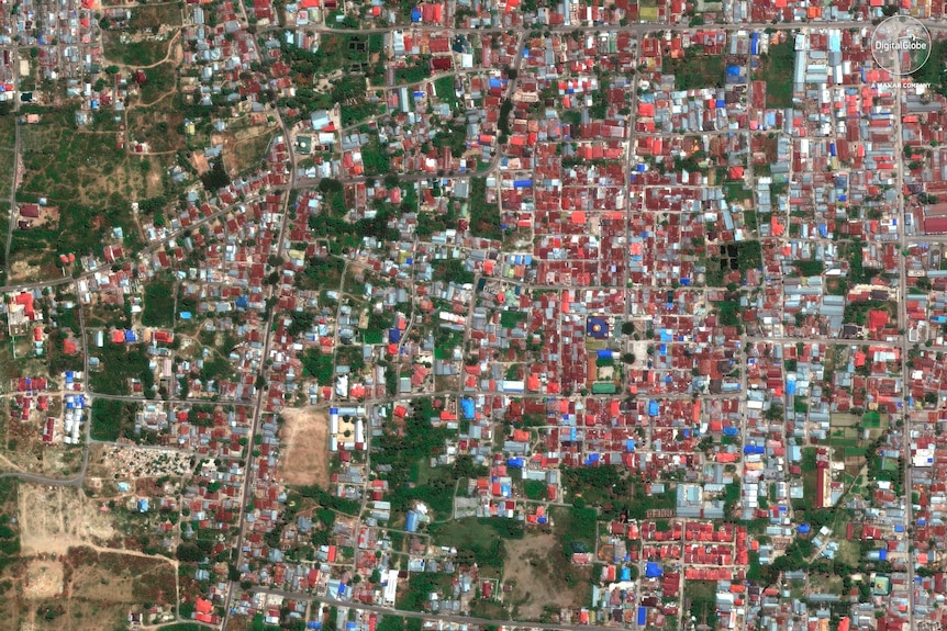 This August 17, 2018, satellite image provided by DigitalGlobe shows the Balaroa neighbourhood of Palu, Indonesia.