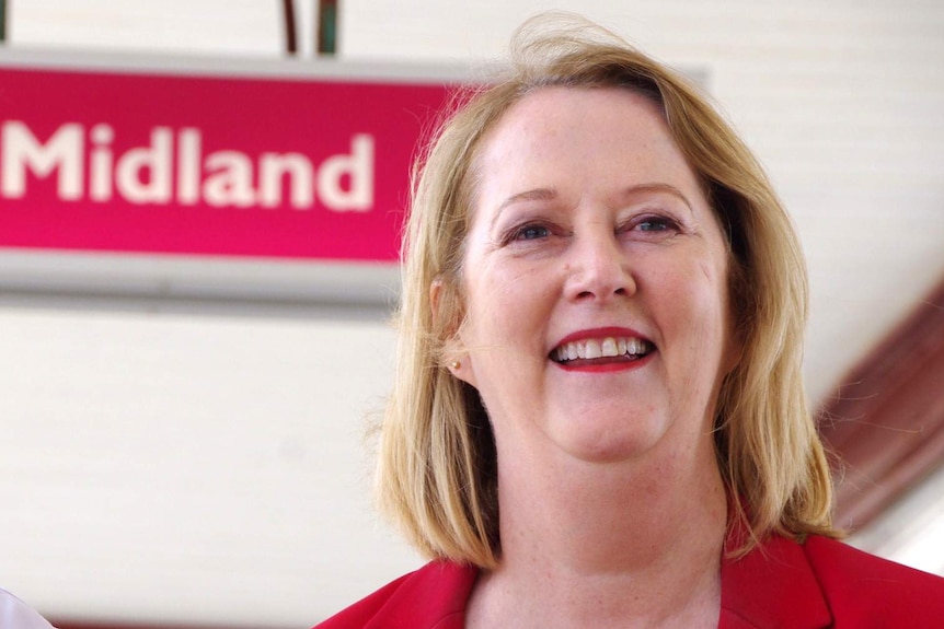 Headshot of Michelle Roberts with a sign saying "Midland" behind her.