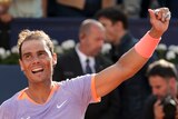 Rafael Nadal smiles and raises his left fist after winning a match at the Barcelona Open.