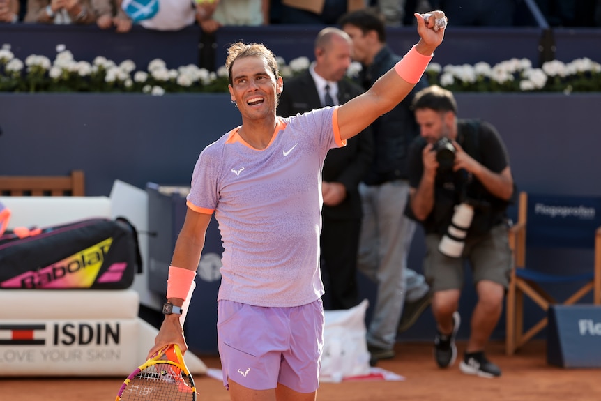 Rafael Nadal smiles and raises his left fist after winning a match at the Barcelona Open.