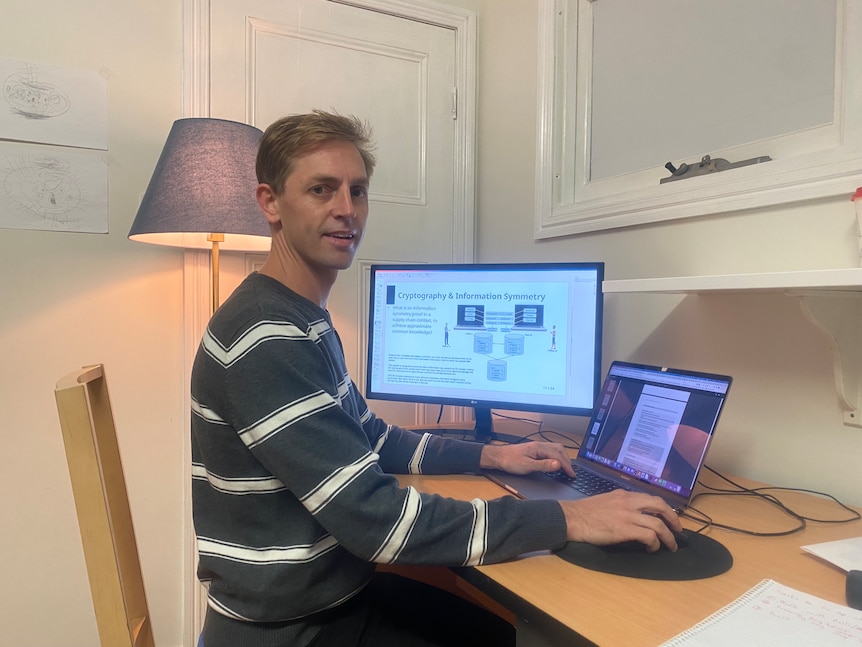 Tom Miller sits at his desk.