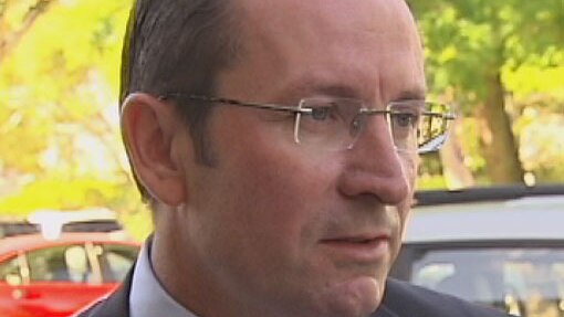 Mark McGowan outside with cars behind