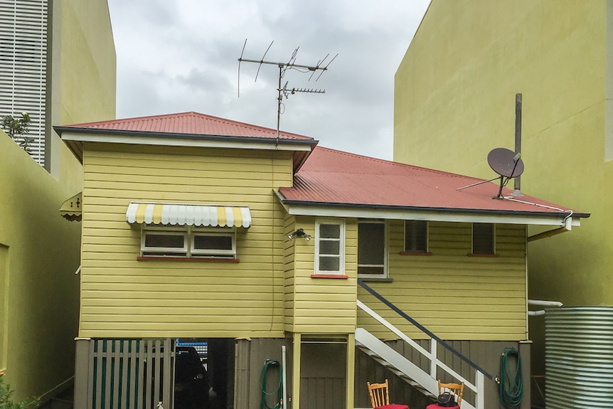 Tall walls tower over either side of the Mollison Street home in Brisbane's West End.