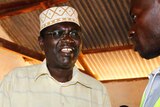 Malik Obama talks to a polling official after voting.