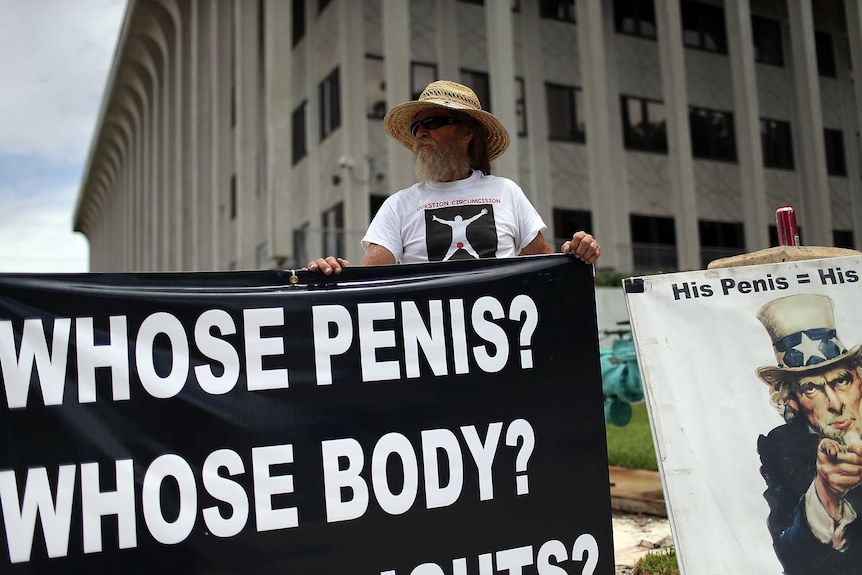 A man protests outside a courthouse in the US