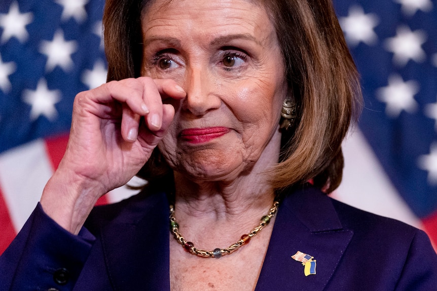 House Speaker Nancy Pelosi wipes her eye as she becomes emotional before signing the Respect For Marriage Act.