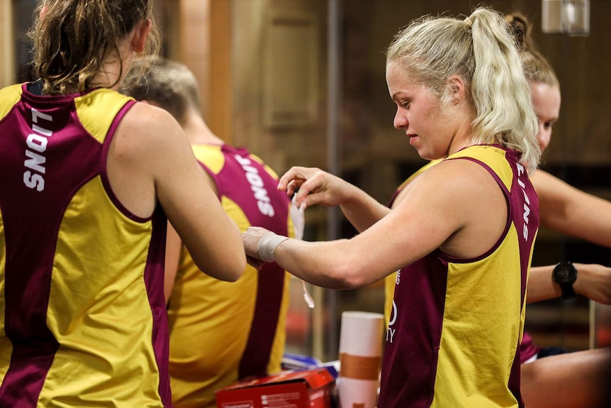 Brisbane Lions female players in the locker room at training in Brisbane.