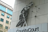 the county court logo on the facade of a building