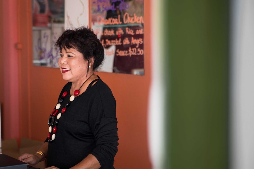 Amye Un behind the counter at her restaurant.