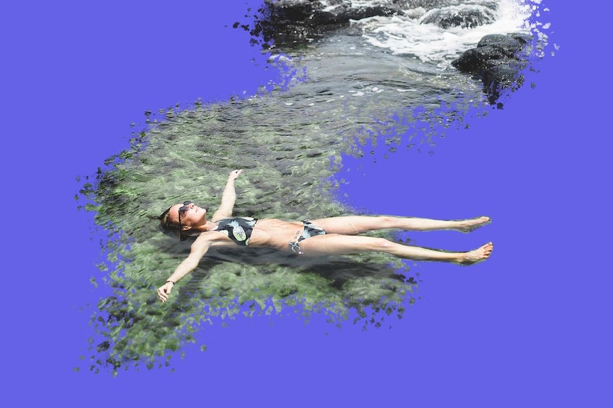 A woman floats on her back in the ocean to spend time offline