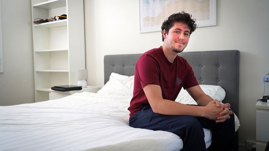 William Venneste is looking for a new flatmate he is sitting on a bed inside an apartment in lane cove