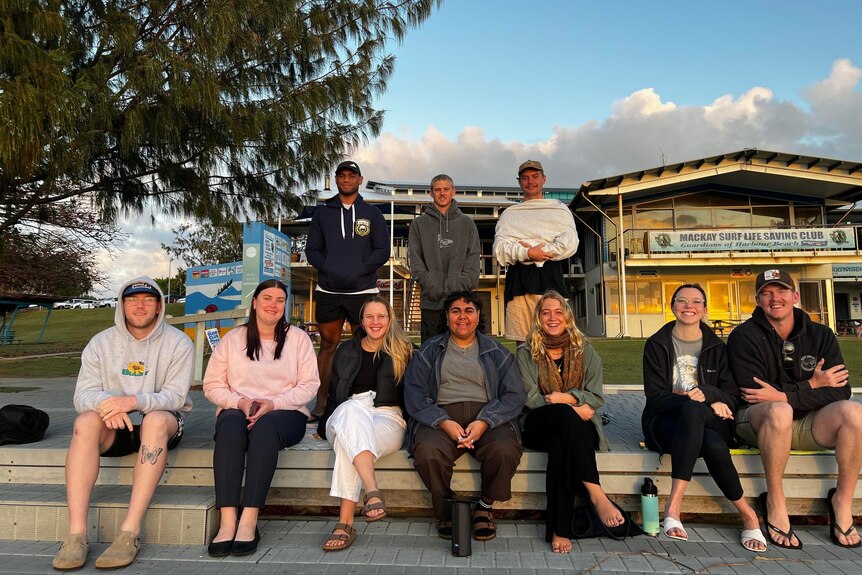A group of young people in front of the Mackay Harbour Surf Club. 