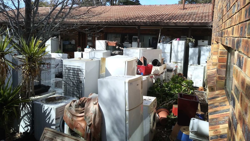 The backyard of a home filled with dozens of whitegoods.