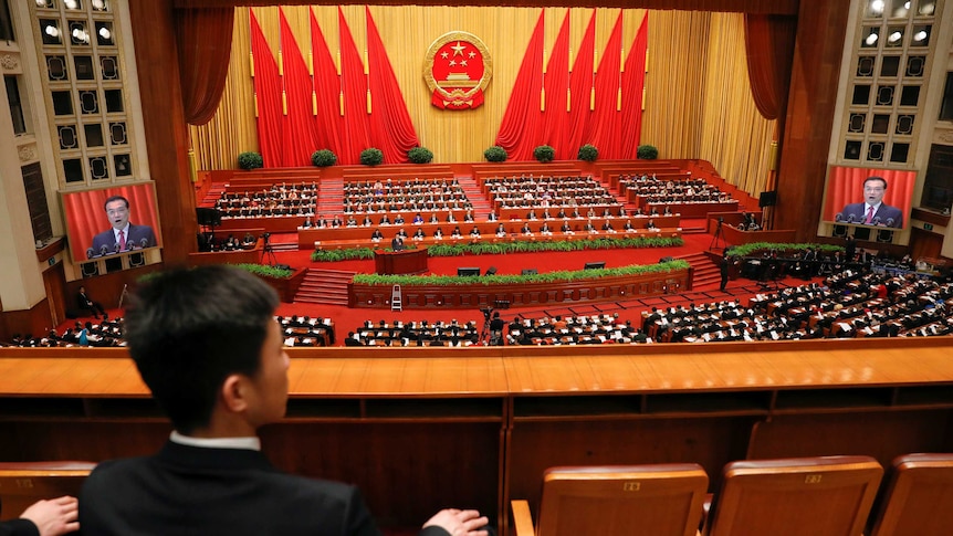 Security officers sit at the National People's Congress in Beijing