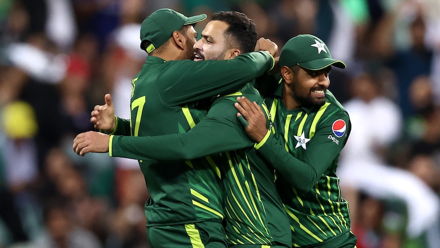 Mohammad Nawaz hugs his teammates while smiling