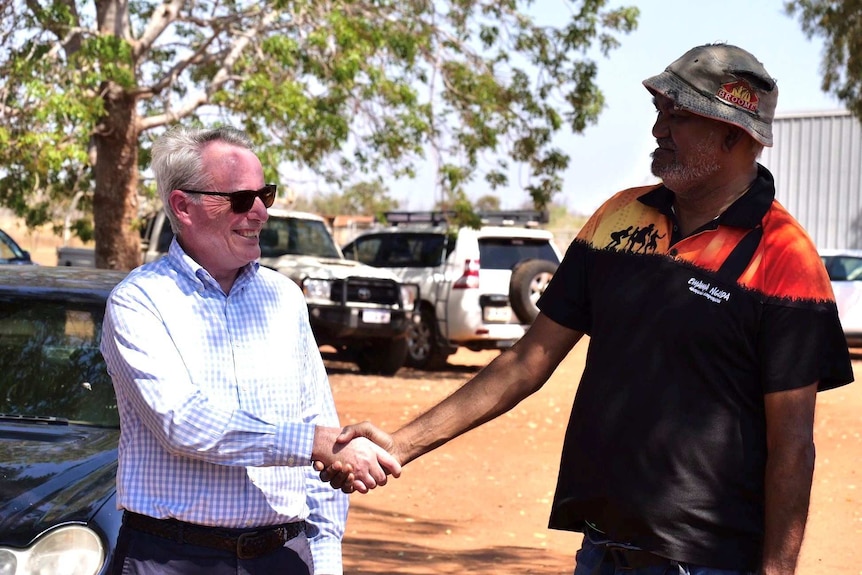 Two men shaking hands at the Kimberley Turf Farm