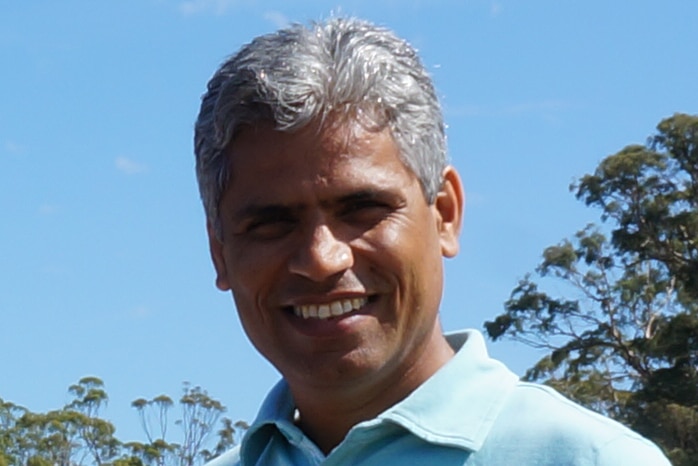 Head shot of man wearing blue t-shirt on a sunny day