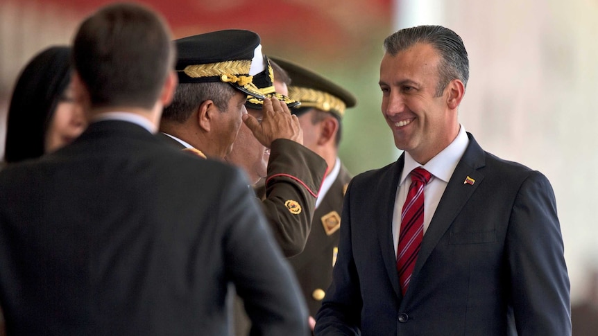 An army officer salutes Venezuela's Vice-President Tareck El Aissami.
