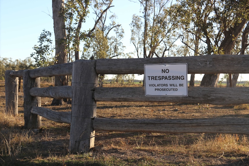 A "no trespassing" sign located on the fence at the entrance of Lemontree Feedlot.