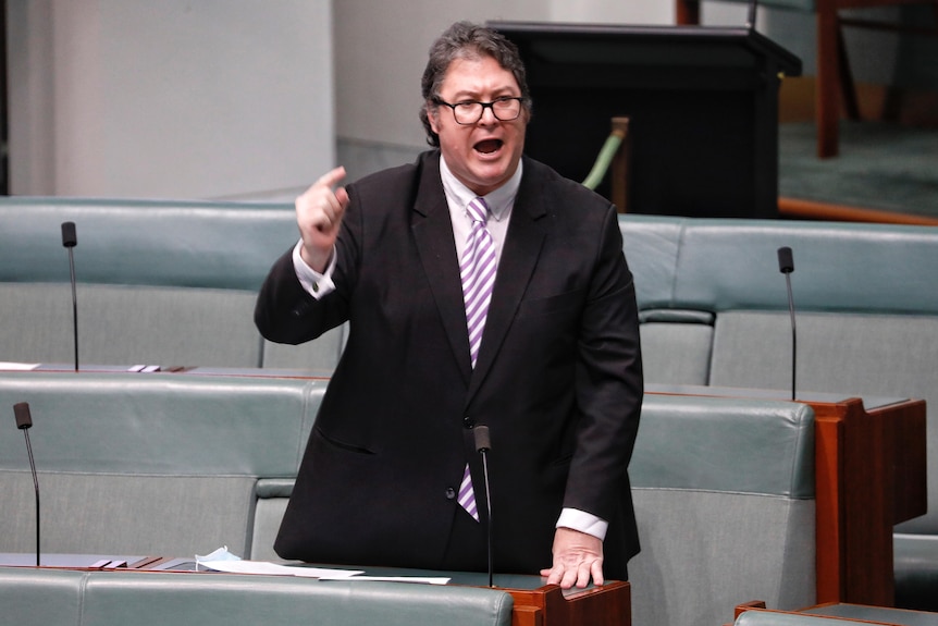 A man shouts and points his finger while making a speech inside the House of Representatives at Parliament House.