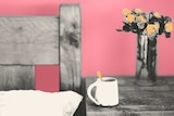 Photo and illustration of bedside table with flowers and mug
