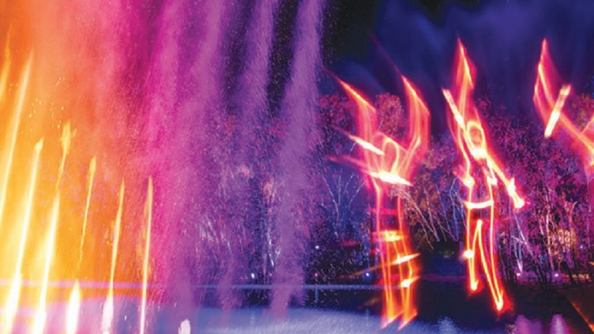 Figures lit up in yellow, purple, and orange colours at a laser light show.